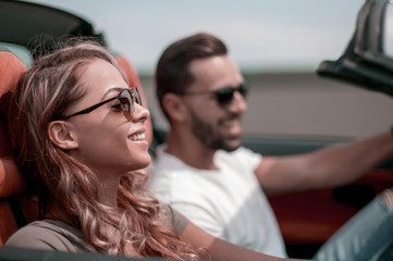 close up.a young woman with her boyfriend in a convertible car