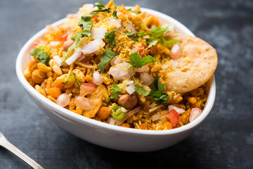 Bhelpuri Chaat/chat is a road side tasty food from India, served in a bowl or plate. selective focus