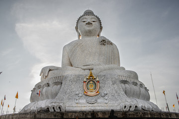 Fototapeta premium big white buddha in the bright warm light of the sun