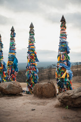ritual wooden poles tied with multi-colored pieces of cloth - 275034341