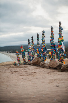 ritual wooden poles tied with multi-colored pieces of cloth