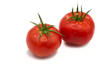 ripe fresh organic tomatoes in drops of dew isolated on white background