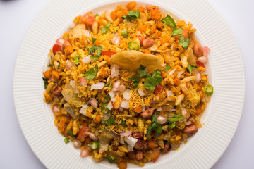 Bhelpuri Chaat/chat is a road side tasty food from India, served in a bowl or plate. selective focus
