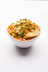 Bhelpuri Chaat/chat is a road side tasty food from India, served in a bowl or plate. selective focus