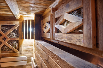 Fototapeta na wymiar Handmade bath in the spa complex. The bath is trimmed with planks and hay.