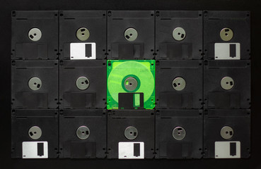 retro floppy from old computer on black background. not like everyone else.