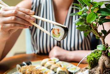 woman eating sushi in the restaurant
