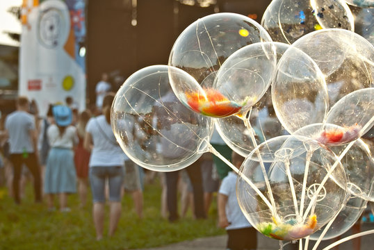 August 16, 2019. Chernivtsi, Ukraine. Youth, musical ethno festival "Obnovafest". Many people are standing by the scene at the music festival. Balloons with garlands on the background of the scene.