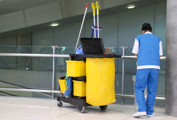 Closeup of woman cleaning worker doing her work with cleaning equipment and tools.