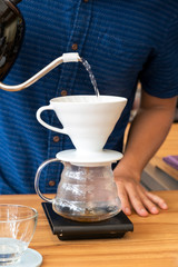 Barita is making coffee in the shop.