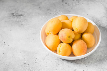 Apricots on a light background. Light grey background
