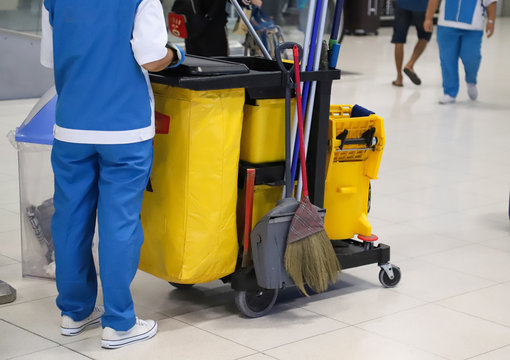 Closeup of woman cleaning worker doing her work with cleaning equipment and tools for floor cleaning at the airport. 