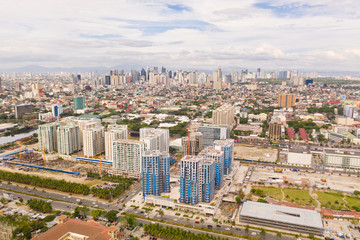 Naklejka na ściany i meble Construction of high modern houses in Manila. The city of Manila, the capital of the Philippines. Modern metropolis in the morning, top view. New buildings in the city.