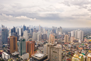 Fototapeta premium The city of Manila, the capital of the Philippines. Modern metropolis in the morning, top view. New buildings in the city. Panorama of Manila. Skyscrapers and business centers in a big city.