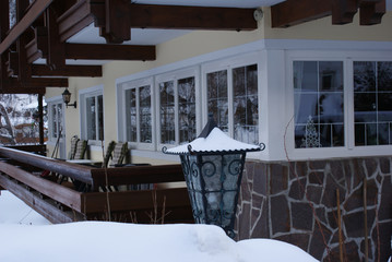 A house covered with white snow in the Alps in winter