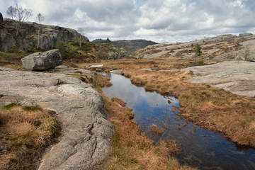 Beautiful landscape of nature in Norway, a creek among the boulders the top of the mountain plateau