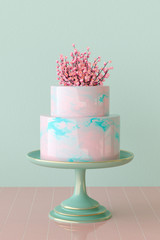 3D rendering of a pink and turquoise marbled mirror glaze cake on cake stand