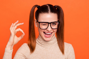 Portrait content lady eyewear eyeglasses advertise cheerful recommend ads sale discount nerd present tip indicate choose decide adverts turtleneck stylish trendy beautiful isolated orange background