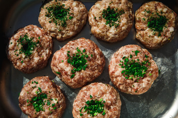 Meat products: cutlets, stuffed cabbage, meatballs in bacon. Fresh appetizing meat store products in metal trays