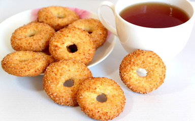 A variety of shaped cookies. White cup of tea. Morning is sweet. Tea ceremony.