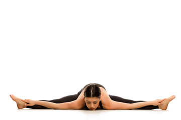 Fototapeta premium Flexible young woman doing yoga side leg and arms splits on white background 