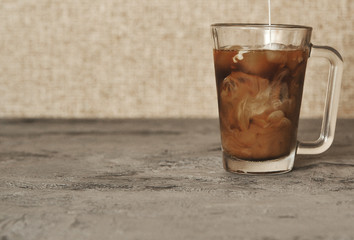 Iced coffee on stone background. Summer cold drink.