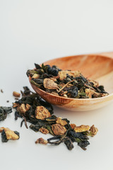 Dried tea leaves close up on white background