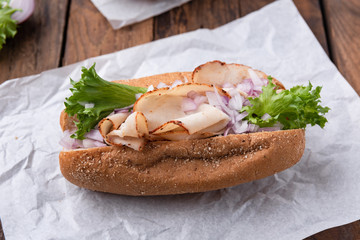 Hotdog with breast turkey on wood