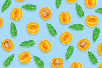Apricot and menta pattern. Top view of fresh fruit on a blue pastel background.