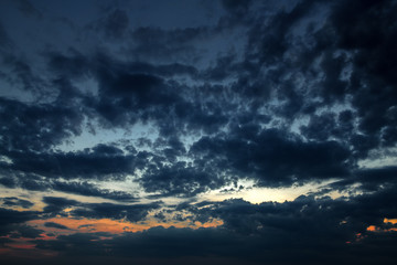 Naklejka na ściany i meble Dark sky with clouds at sunset
