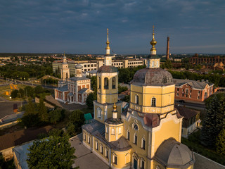 Aerial view of the ancient Orthodox Christian monastery, located among the houses and nature in the city of Serpukhov. Early summer morning. Moscow region