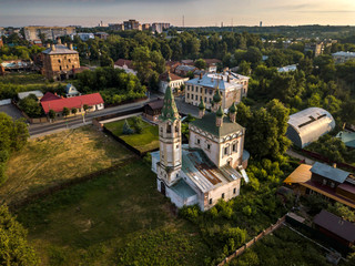 Aerial view of the ancient Orthodox Christian monastery, located among the houses and nature in the city of Serpukhov. Early summer morning. Moscow region
