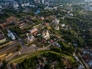 Obraz premium Aerial view of the ancient Orthodox Christian monastery, located among the houses and nature in the city of Serpukhov. Early summer morning. Moscow region
