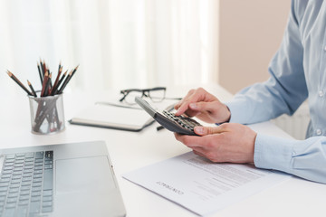 Fototapeta premium Office desktop with laptop and a business man