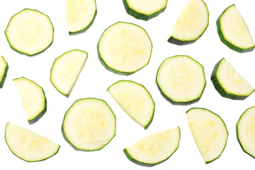 fresh green zucchini slices isolated on white background. top view
