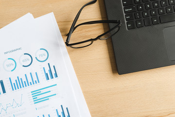 Office desktop with laptop and a glasses