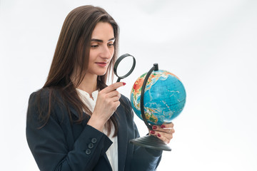 Fototapeta premium Woman looking at globe with magnifying glass isolated