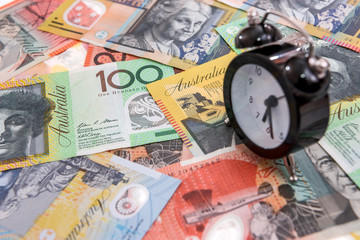Clock with alarm at australian dollars close up