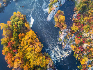Fototapeta na wymiar colorful forest, blue river and rocks. natural beautiful autumn landscape (background). drone shot, bird's-eye, aerial view