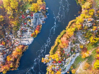 colorful forest, blue river and rocks. natural beautiful autumn landscape (background). drone shot, bird's-eye, aerial view