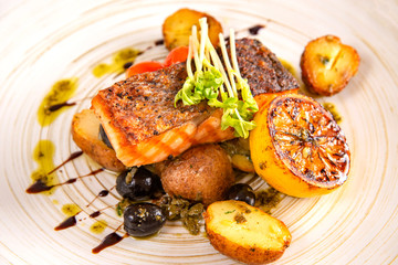 Salmon steak grilled with lemon on white background