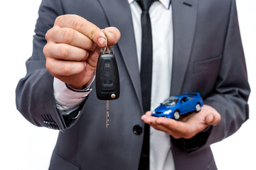 Man holding toy car and keys isolated on white