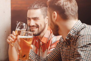 Meet friends of men in beer bar, happy smiles on your face