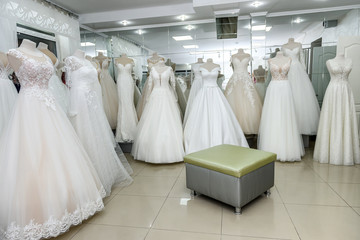 Interior of bridal salon, wedding dresses on mannequins