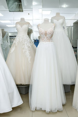 Fototapeta na wymiar Beautiful wedding dresses on a mannequin in bridal shop