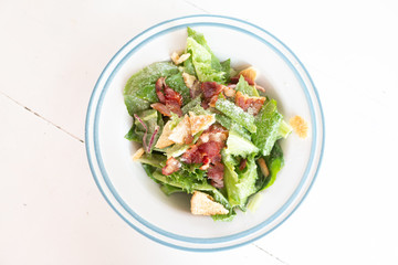 Closeup of healthy Caesar salad with croutons and Ham sliced
