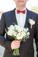 Morning groom, Groom in a jacket, The groom straightens the buttonhole, wedding day
