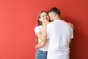 Naklejka premium Portrait of happy young couple on color background