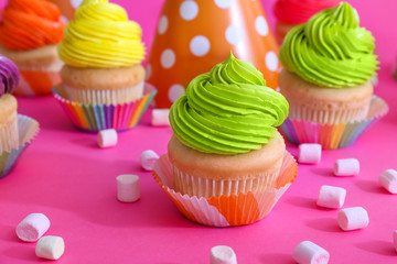 Sweet tasty cupcakes on color background
