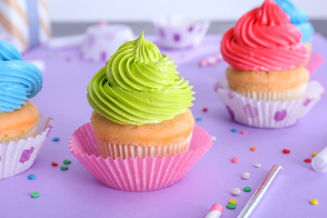 Tasty Birthday cupcakes on color background
